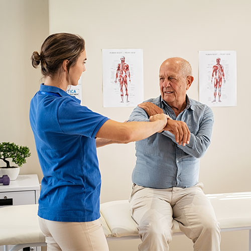 female physical therapist with elderly patient with shoulder pain